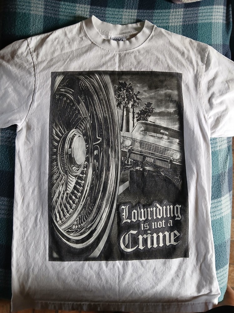 T-Shirt “Lowriding is not a Crime” design printed on a Shaka Wear blank Size L